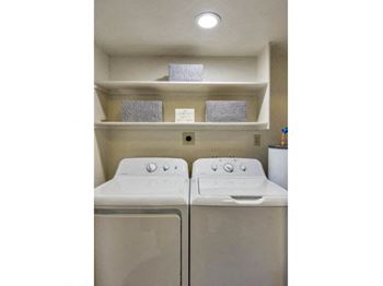 Two washing machines in a small laundry room.